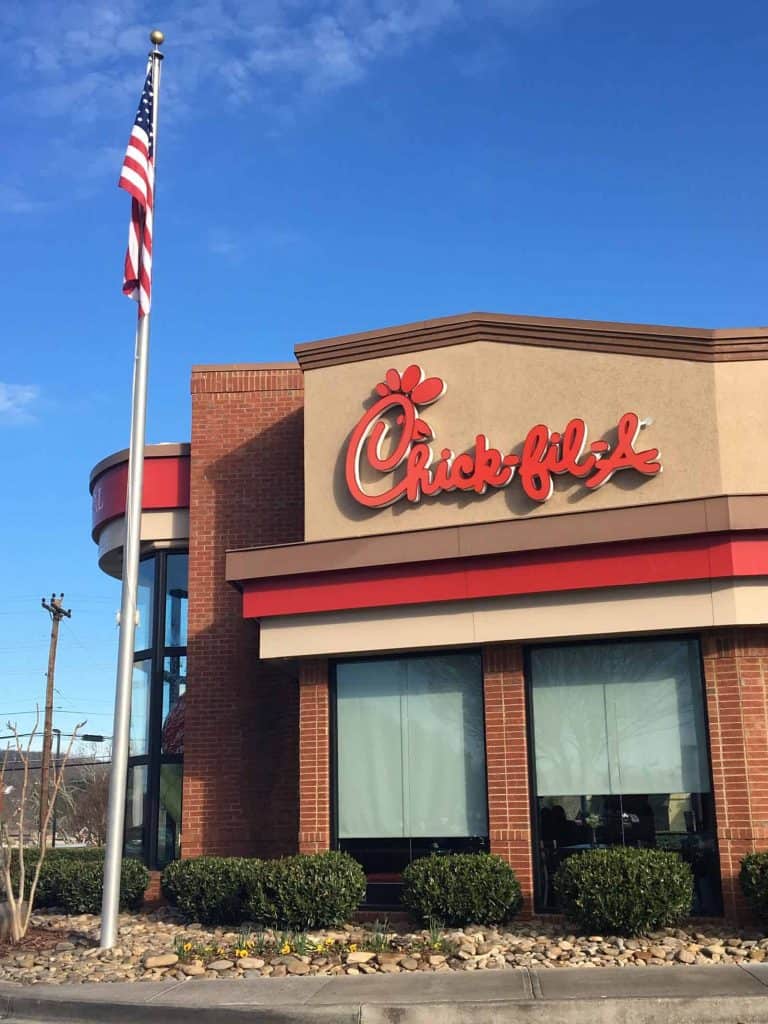 A Chick-fil-A store with a US flag outside