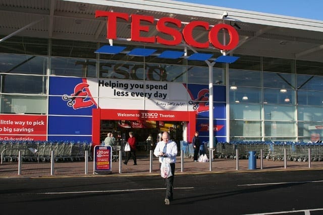 A Tesco store in the UK with people walking in and out