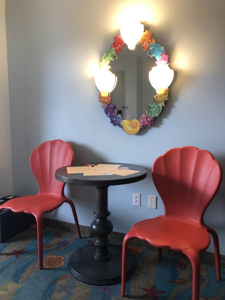 Table and chairs styled like clam shells  inside the Little Mermaid rooms as part of the Disney Art of Animation review