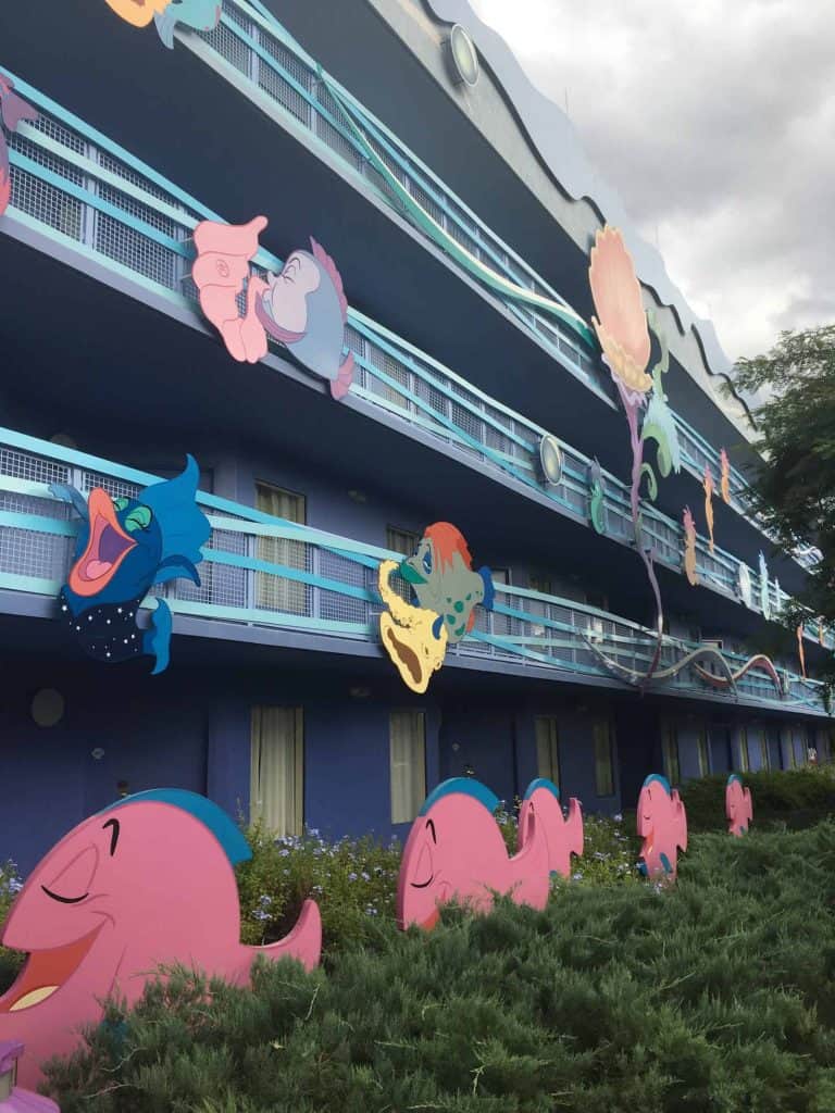 Exterior of Disney Art of Animation Little Mermaid area with fish attached to balconies swimming around