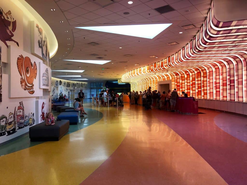 Inside the Disney Art of Animation lobby, with animation artwork on the walls