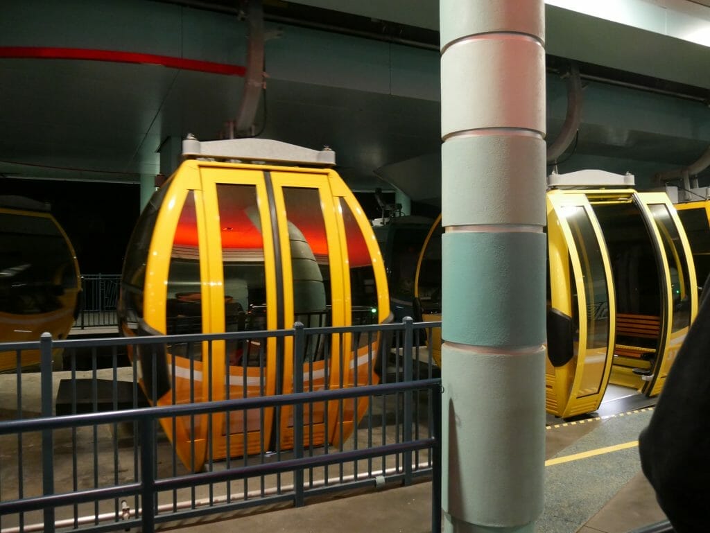 Two Disney Skyliner cars inside a station