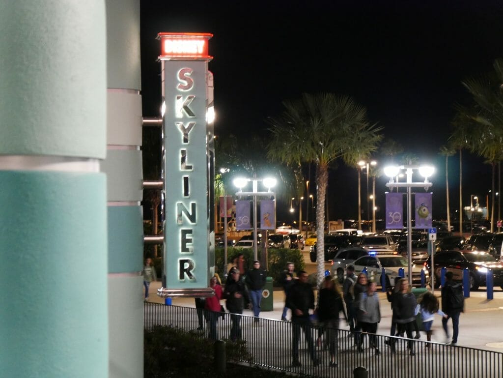 Disney Skyliner sign at night lit up