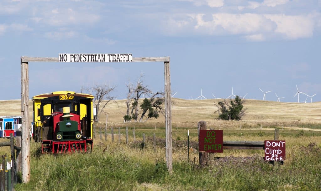 Terry Bison Ranch Wyoming with train and signs in field