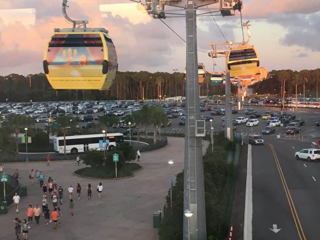 Disney World Skyliner cars above a parking lot