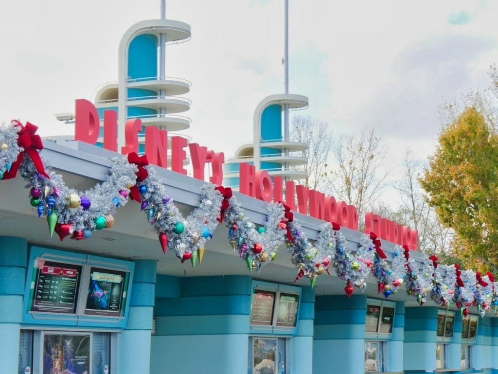 Hollywood Studios entrance decorated for Christmas with tinsel