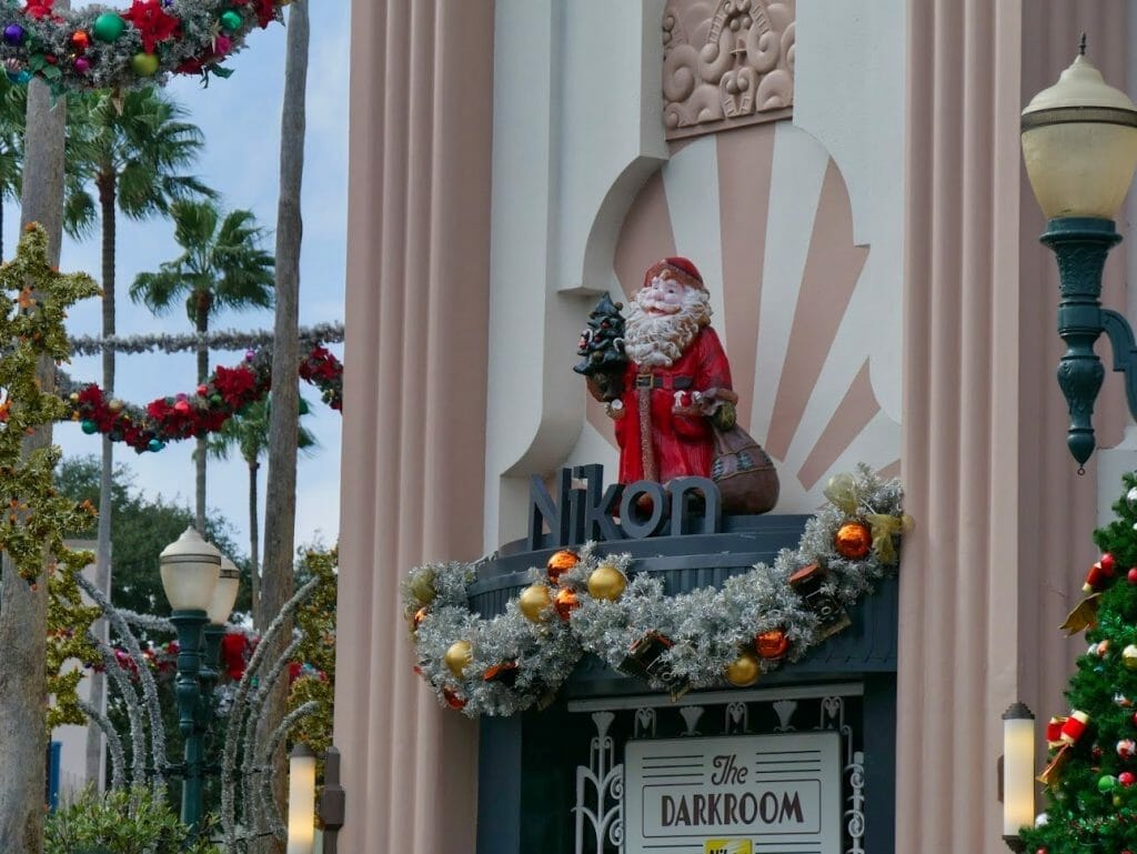 A Nikon sign with a Santa statue on top