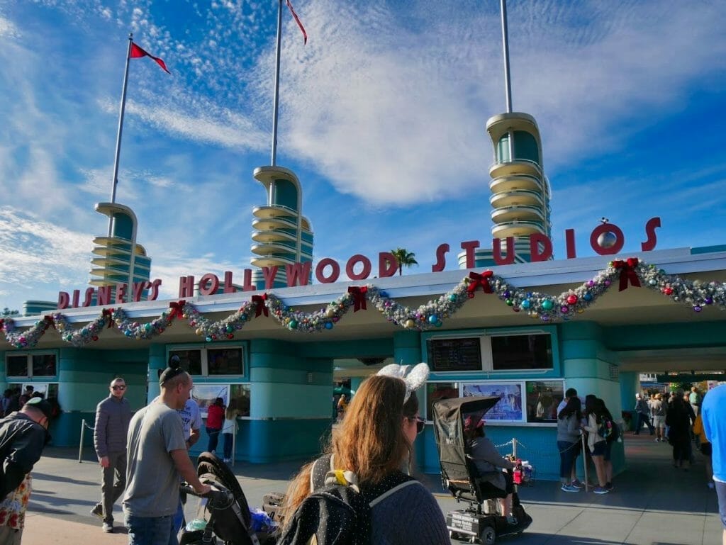 Hollywood Studios entrance decorated for Christmas with tinsel