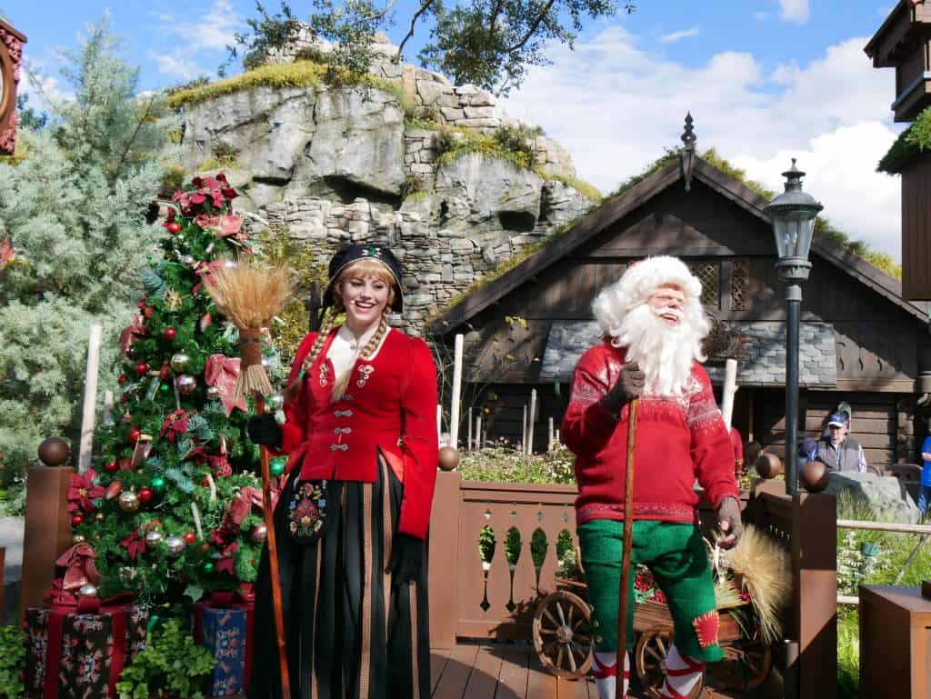 A Father Christmas character and female character on stage in the Norway area at Epcot, Disney World at Christmas