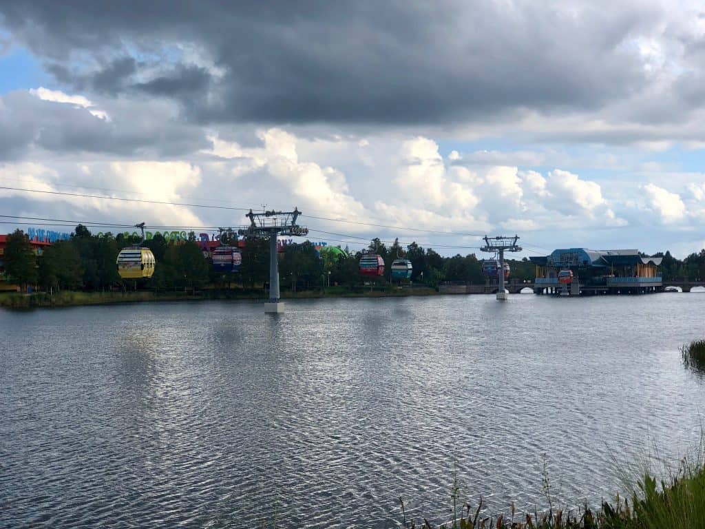 Disney Skyliner cars going over a lake