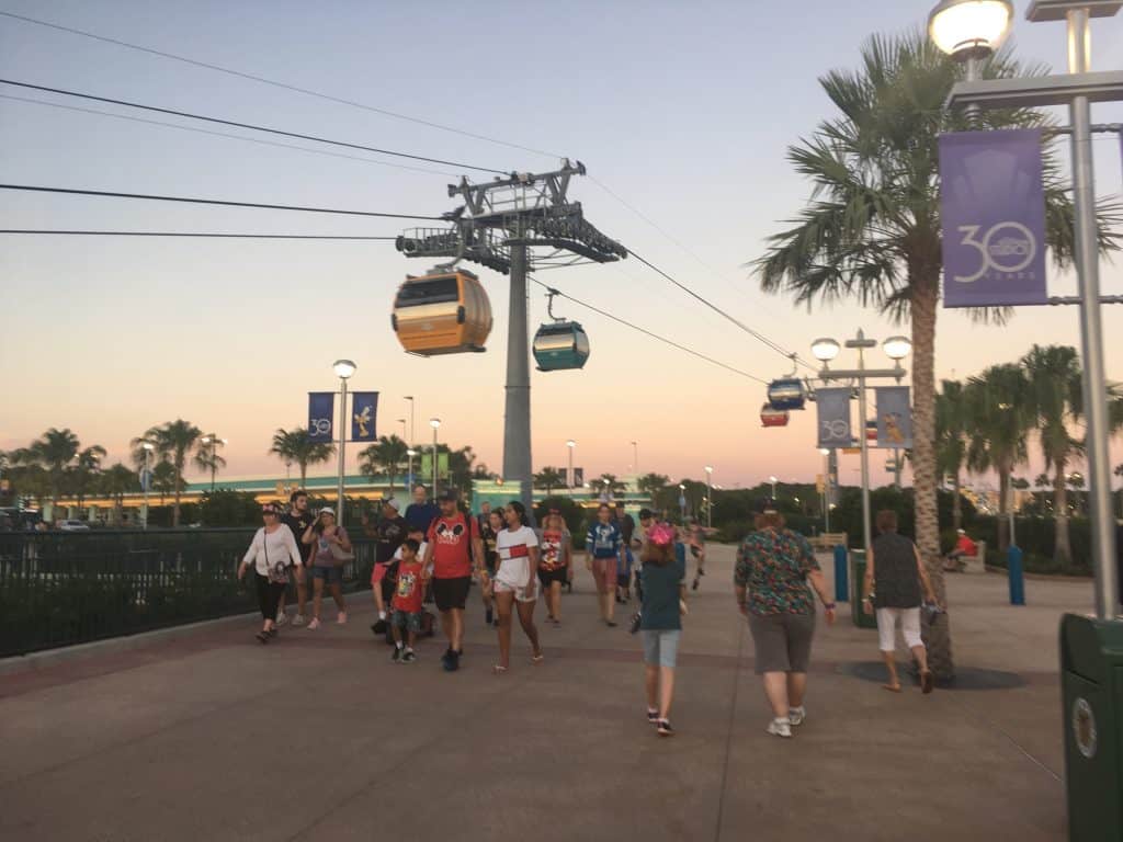 People walking under the Disney Skyliner