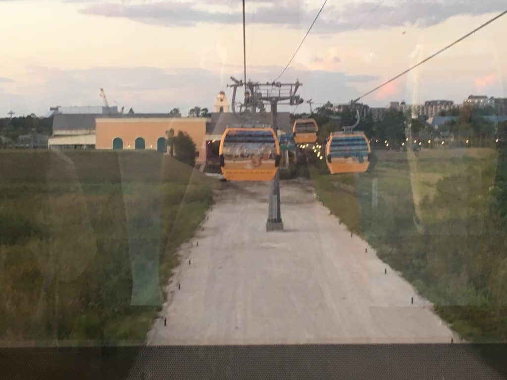 A view from inside the Disney Skyliner with cars in the air