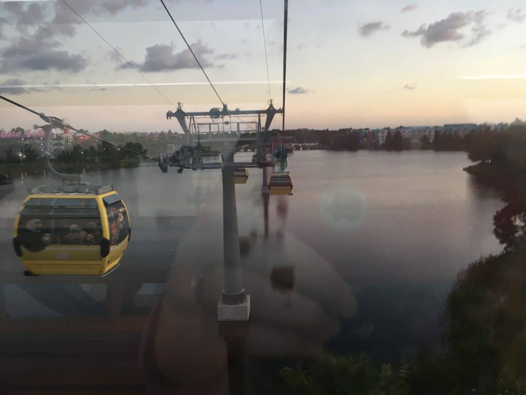 The view from inside a Disney Skyliner car over a lake