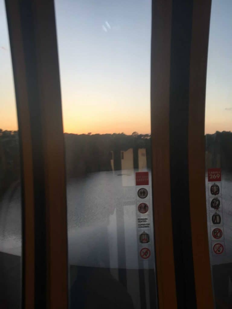 Inside a Disney Skyliner car at sunset