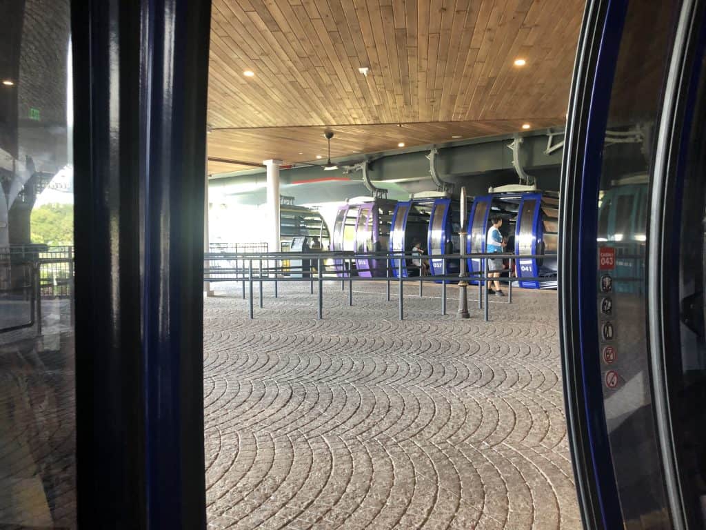 The view from inside a Disney Skyliner car at a station