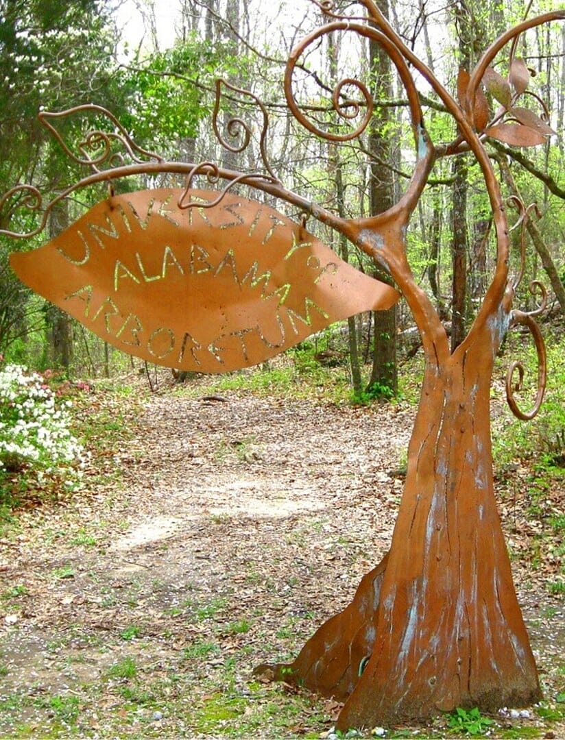 A copper sign made to look like a tree at the University of Alabama Arboretum 