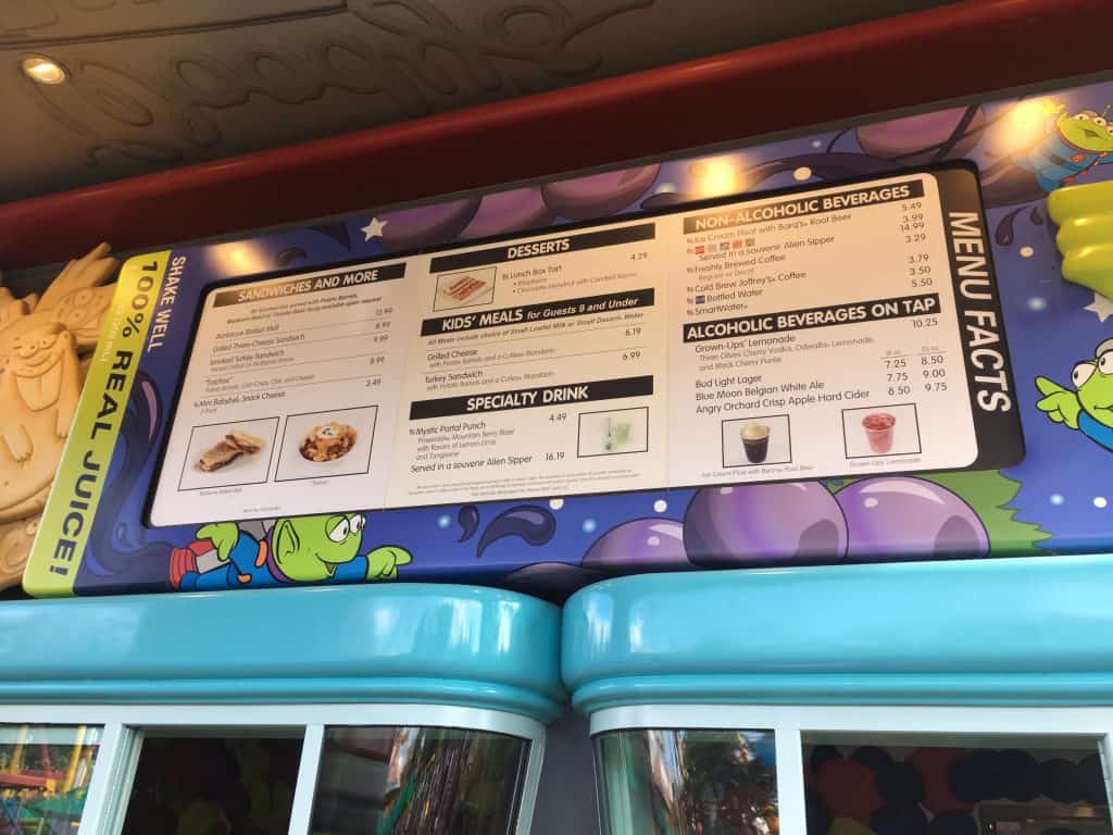 Woody's lunchbox review menu surrounded by Toy Story aliens