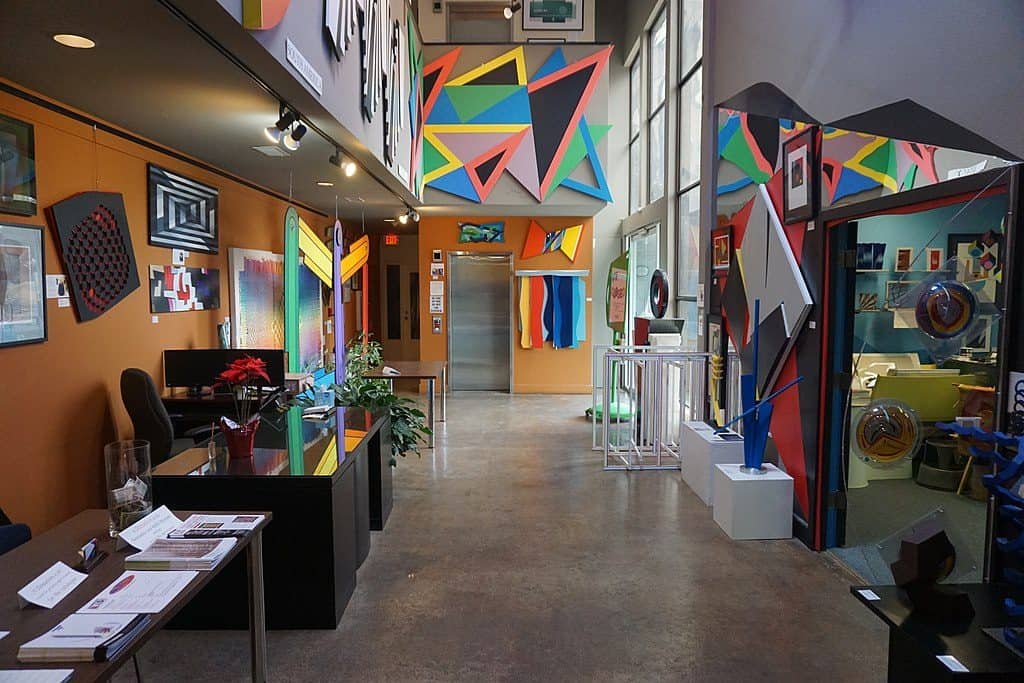 Inside a room at the Museum of Geometric and MADI Art, Dallas, with colourful art piece son the walls