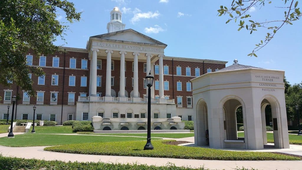 An old, grand, red brick and white stone building at Southern Methodist University, Texas