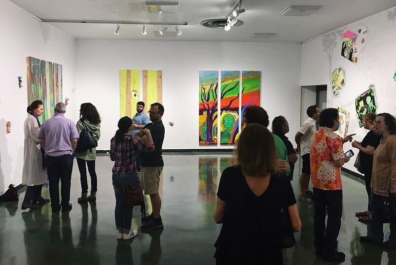 Groups of people gather to view a gallery in Fort Worth