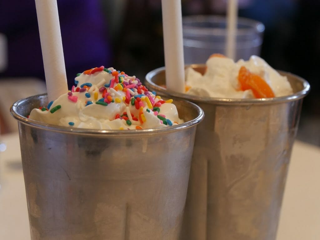 Two milkshakes in mental tumblers with straws