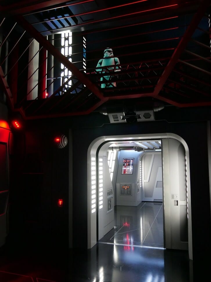 A Stormtrooper looking down on a group in a holding cell in Rise of the Resistance at Hollywood Studios