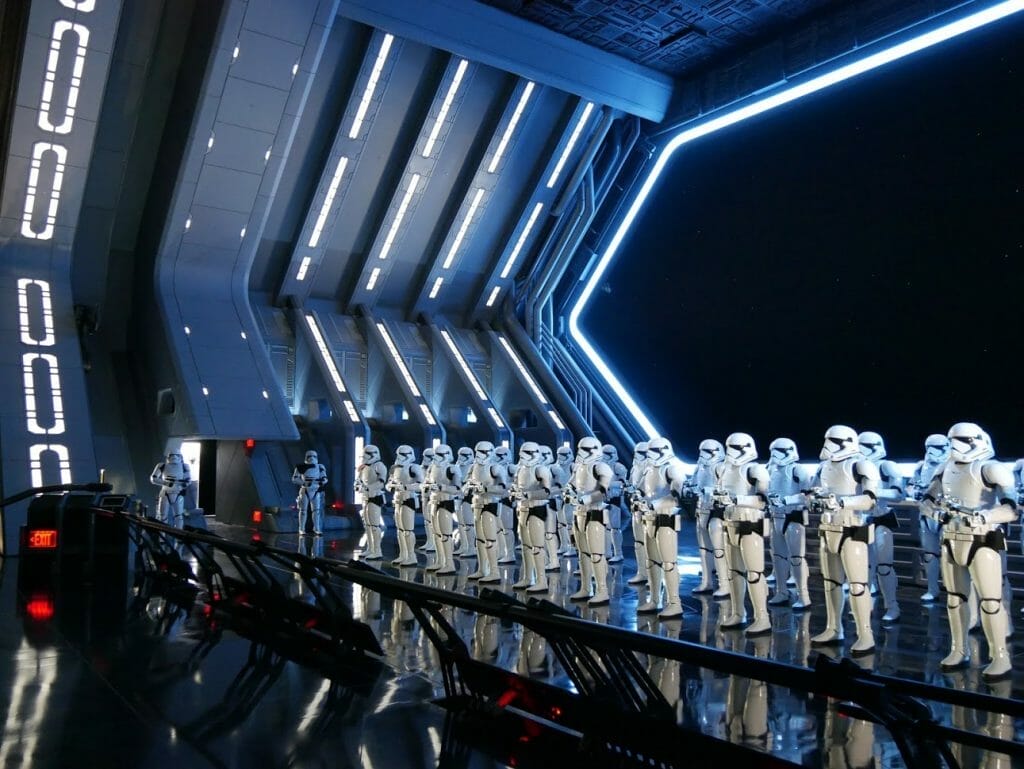 A Star Destroyer hanger with a group of Stormtroopers lined up