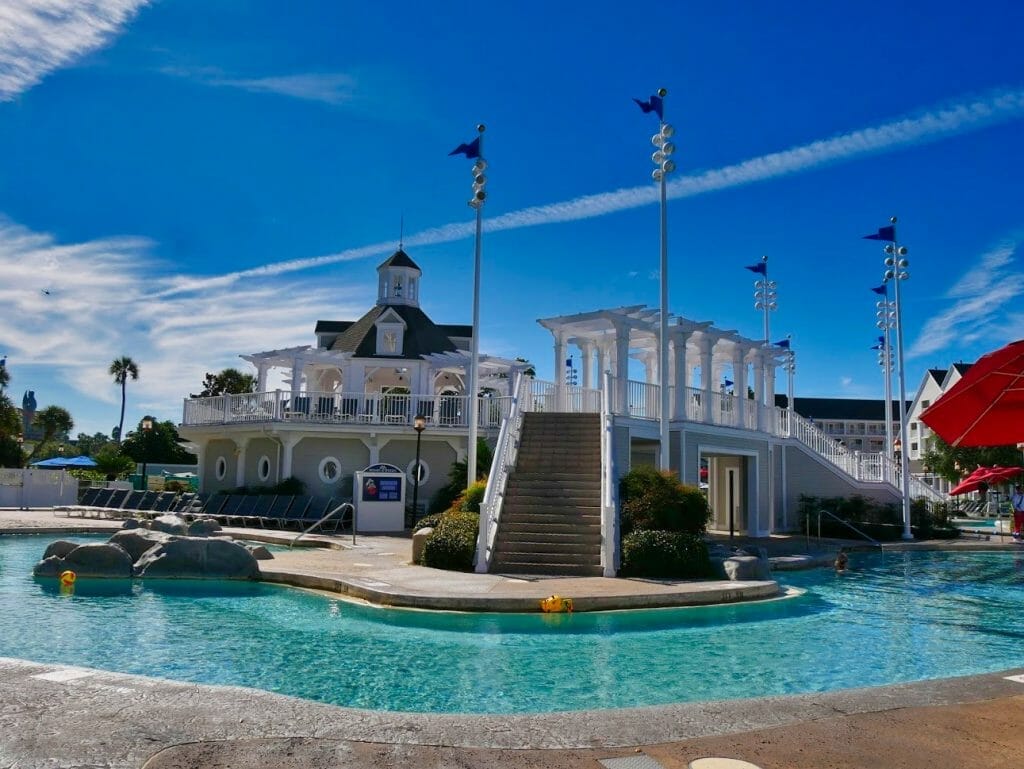 Beach Club swimming pool with a white pool building