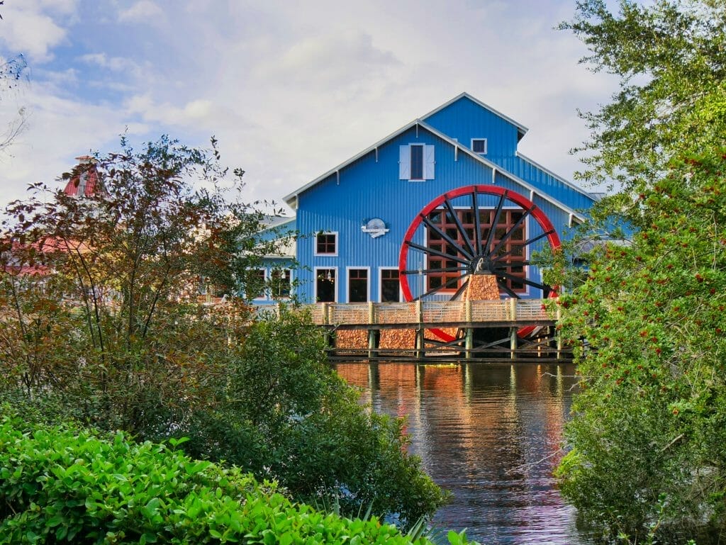A blue building with a red water wheel