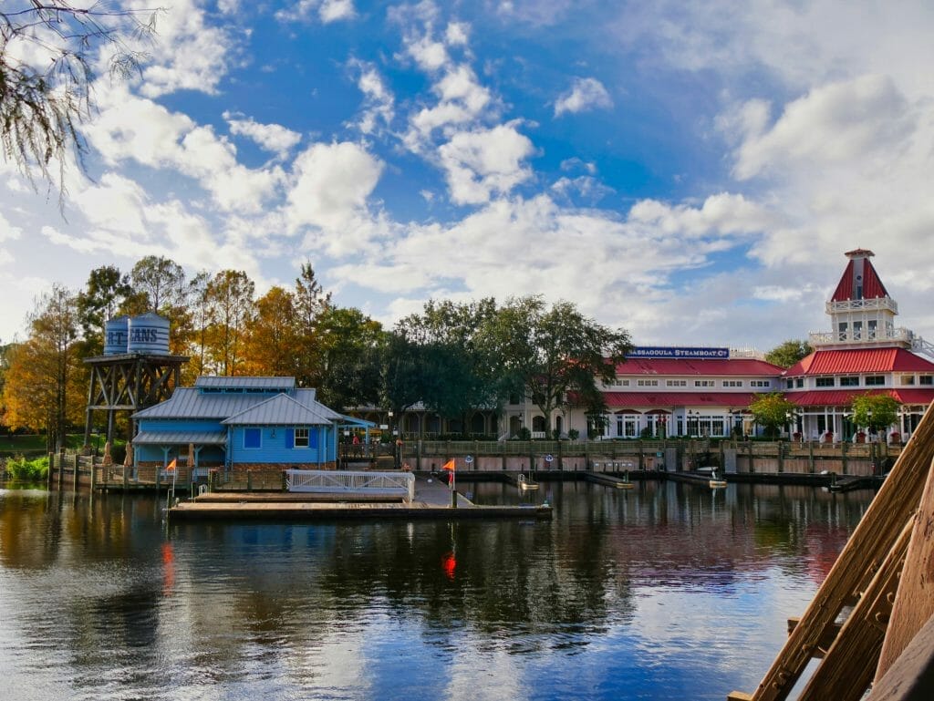 A lake with colorful buildings behind