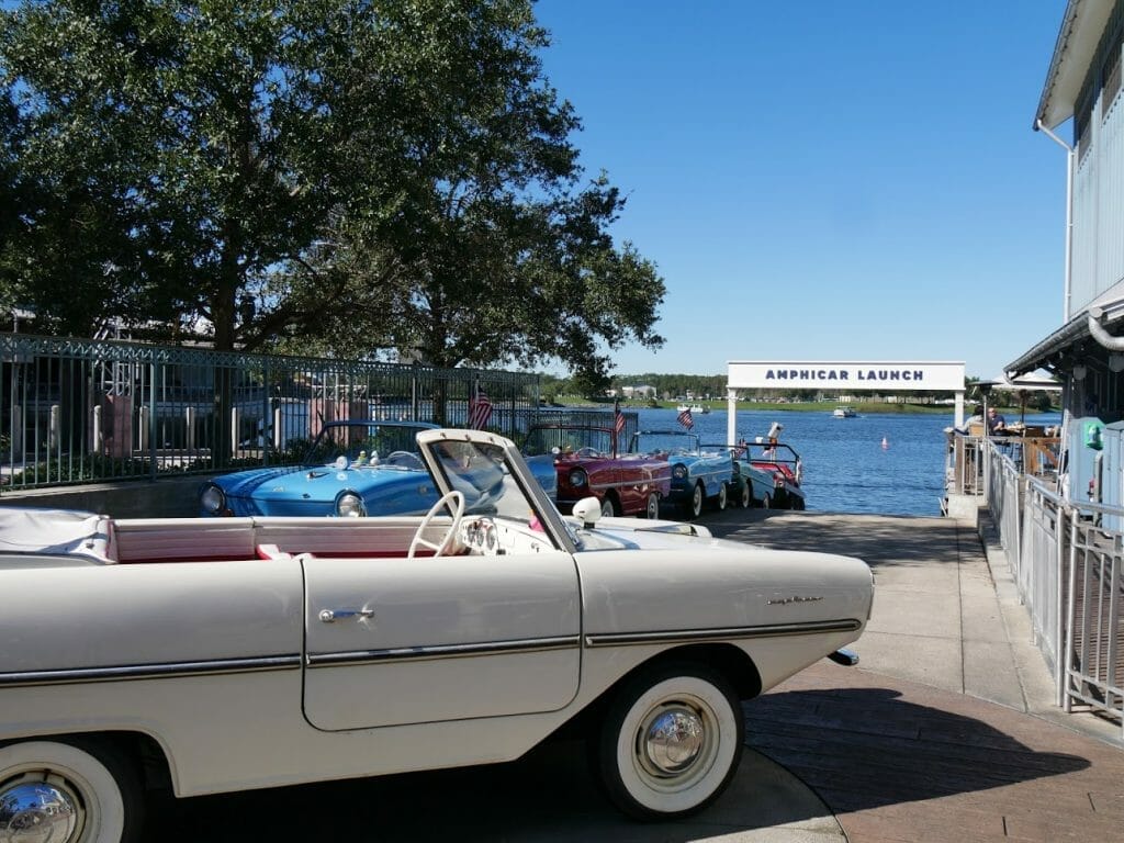 Amphicar Launch at Disney Springs with old school looking car boats lined up in front of the water