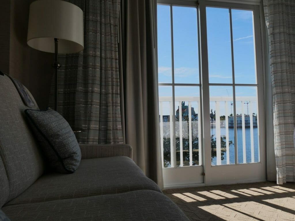 A couch with a view over a lake at Beach Club