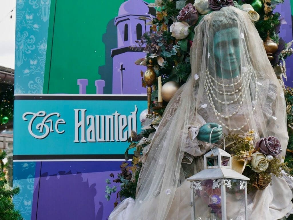 Haunted Mansion Christmas tree with a ghost bride protruding from the tree