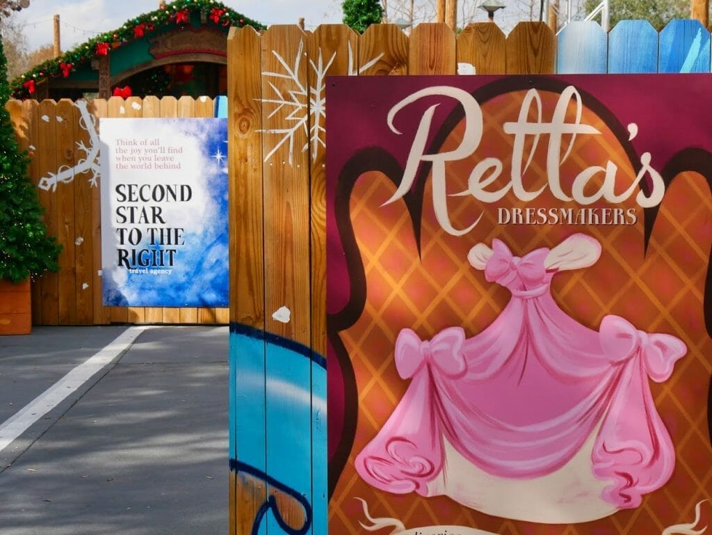 Posters for Retta's Dressmakers and Second Star to the Right Travel Agency in the Disney Springs Christmas Tree Trail