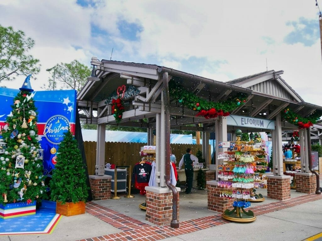 Elforium shop with Fantasia themed Christmas tree next to it and fake snow falling