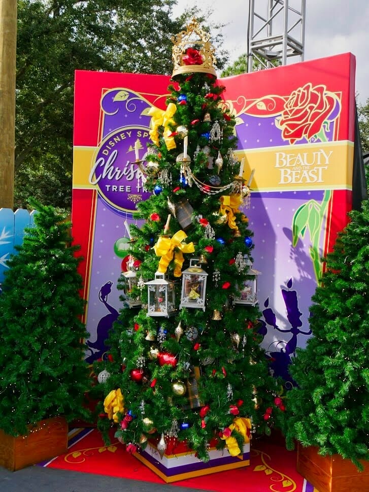A Beauty and The Beast themed Christmas tree with fake snow falling