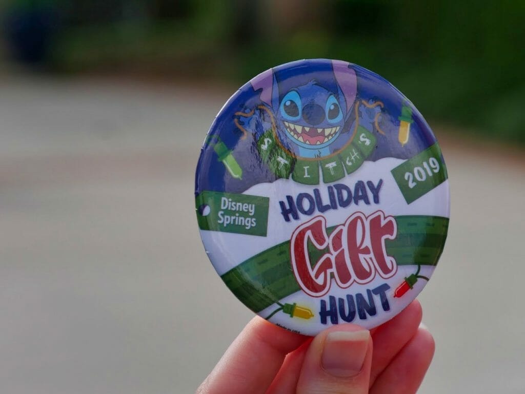 A Holiday Gift Hunt badge button from Disney Springs Christmas Tree walk