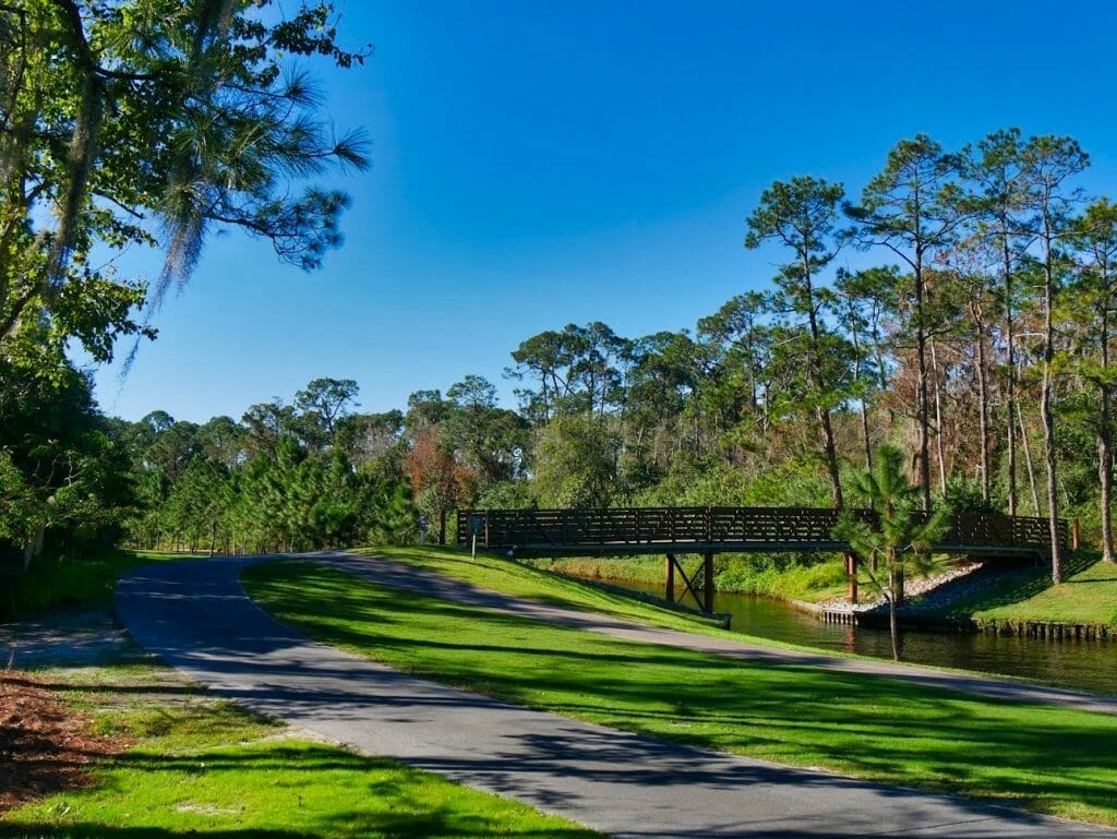 A jogging and walking path next to a golf course and river at Disney World