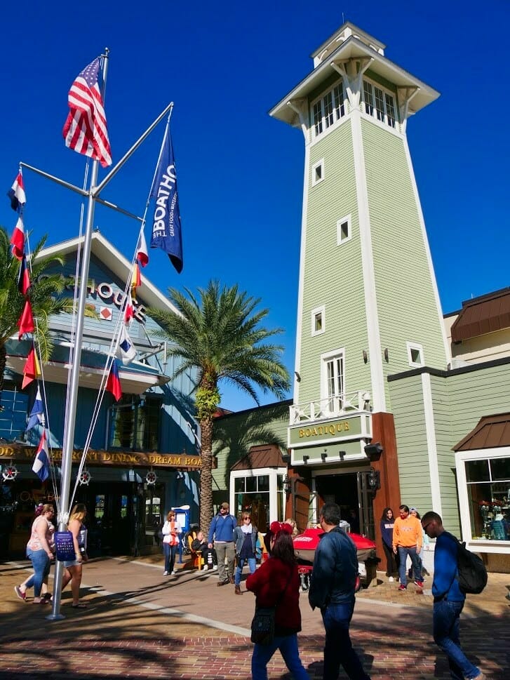 A tall green tower and restaurant building at Disney Springs