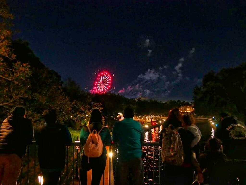 Epcot fireworks seen from a bridge next to the Beach Club resort at night