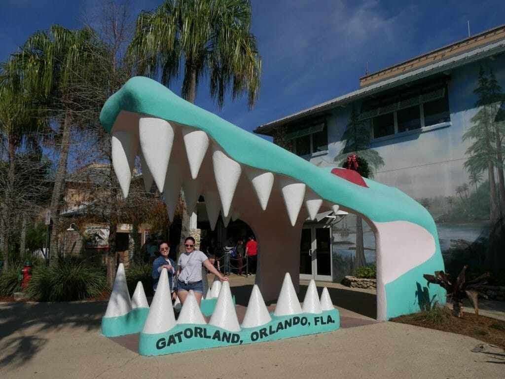 Entrance with a giant gator mouth with people smiling in it