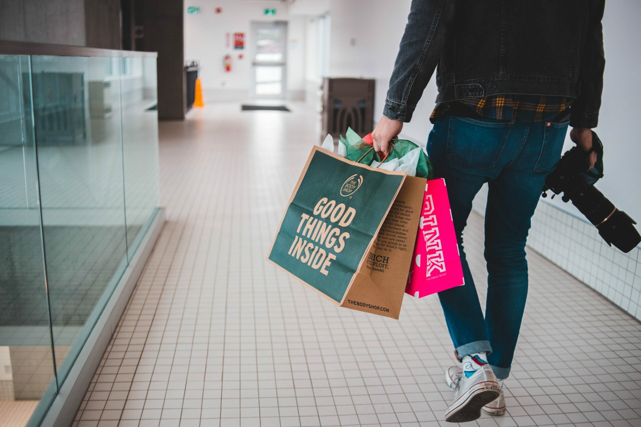 A person carrying shopping bags at a mall