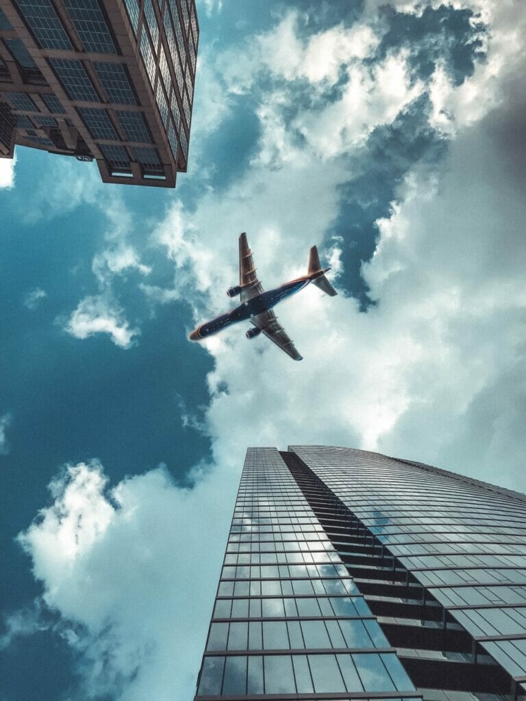 A plane flying with skyscrapers in the background