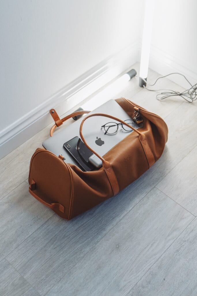 brown carry on bag with laptop