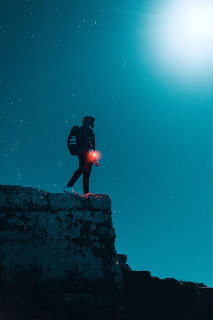 man with flashlight at night