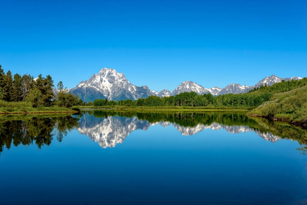 lake with mountain reflecting in it