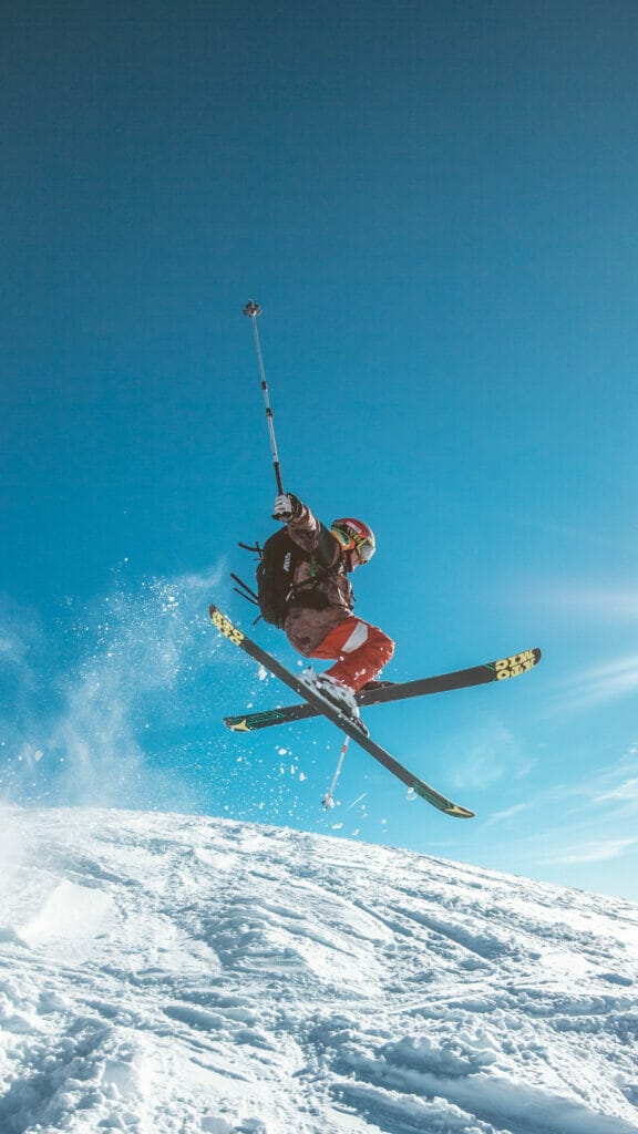 man skiing with blue sky behind him