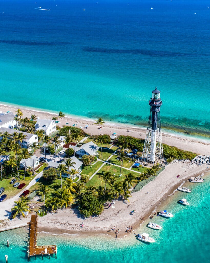 lighthouse and beach with blue water