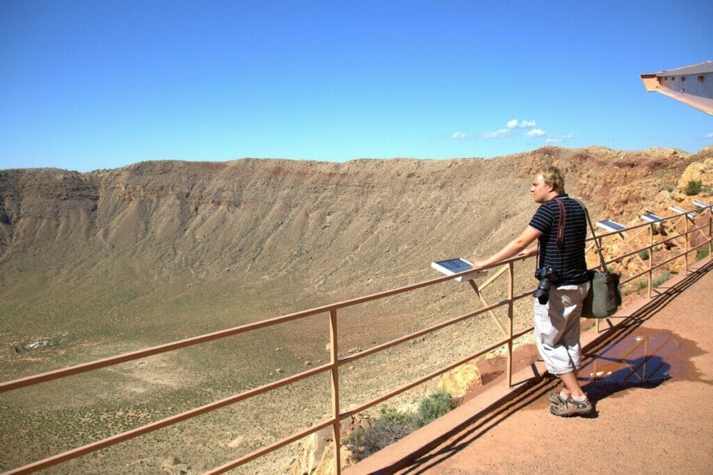 Image of a man standing in front of the Meteor Crater