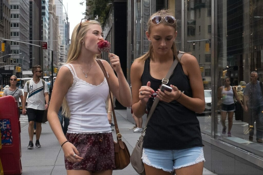 Girls eating candy apples in NYC